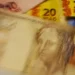 Notas do Banco Central do Brasil mostrando cédulas de 50 e 20 reais com foco no valor do FGC.
