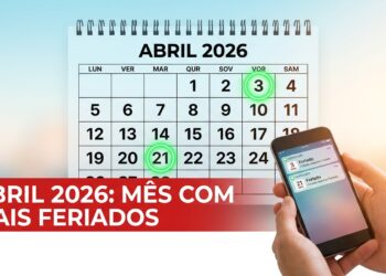 Calendário de abril de 2026 com feriados destacados e celular mostrando notificações de feriados
